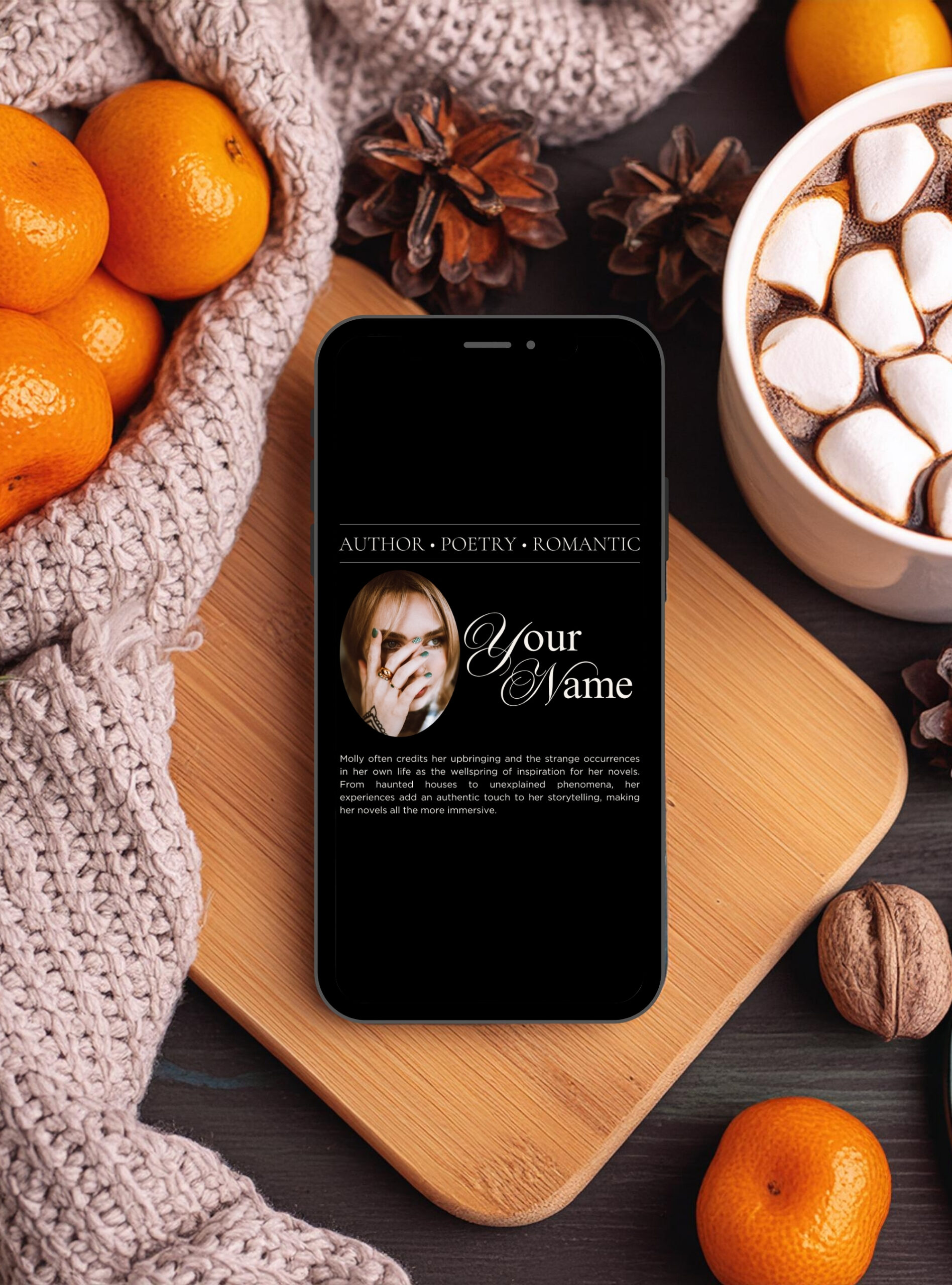 Smartphone on a wooden board showing a gothic author/poetry Instagram template, surrounded by a knit blanket, hot chocolate with marshmallows, pinecones, and winter citrus—cozy dark academia aesthetic.